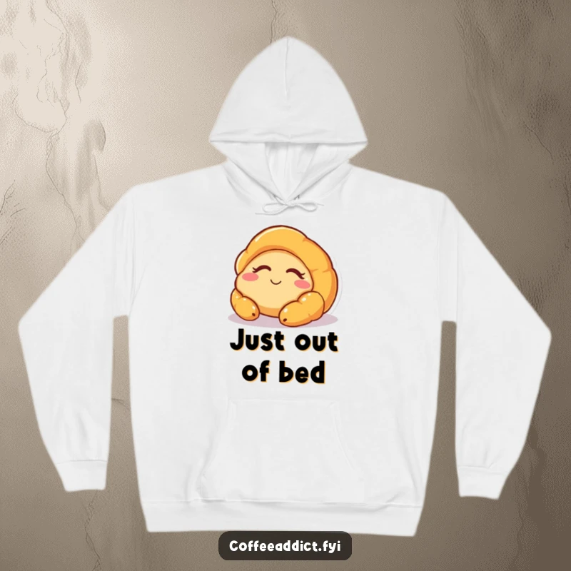 Funny hoodie with a drowsy but happy croissant character waking up slowly, ideal for cozying up on lazy mornings.